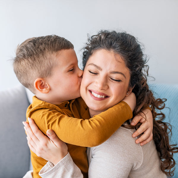 son kissing mother on cheek